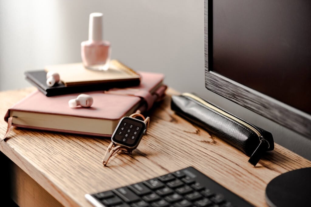 picture of work desk with watch as focus for an article about how to make more money and work less